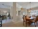 Open concept dining room with neutral paint, tile floors and view of the living room at 4918 Fallcrest Cir, Sarasota, FL 34233