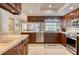 Modern kitchen with stainless appliances, tile backsplash, and ample counter space at 4918 Fallcrest Cir, Sarasota, FL 34233