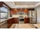 Kitchen featuring stainless steel appliances, tile floors, and generous cabinet space at 4918 Fallcrest Cir, Sarasota, FL 34233