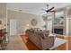 Inviting living room with ceiling fan and fireplace, open to the kitchen at 4918 Fallcrest Cir, Sarasota, FL 34233