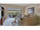 Bright living room featuring sliding glass doors to a screened lanai and comfortable seating at 4918 Fallcrest Cir, Sarasota, FL 34233