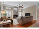 Open concept living room featuring vaulted ceiling, wood flooring, and fireplace at 4918 Fallcrest Cir, Sarasota, FL 34233