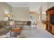 Bright living room with white carpeting and view of dining room beyond double-door entry at 4918 Fallcrest Cir, Sarasota, FL 34233