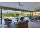 Screened patio with a ceiling fan, outdoor seating, and a pool view at 4918 Fallcrest Cir, Sarasota, FL 34233