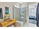 Spa-like bathroom with glass shower, modern vanity, and bedroom view at 8721 Ocean Tides Cv, Parrish, FL 34219