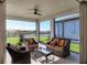 Relaxing screened patio with wicker furniture and lake view at 8721 Ocean Tides Cv, Parrish, FL 34219