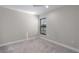 Small bedroom with grey carpet and a window at 12513 Oak Hill Way, Parrish, FL 34219