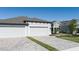 Two-car garage with light gray doors and a paved driveway at 12513 Oak Hill Way, Parrish, FL 34219