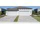 Two-car garage with light gray doors and a paved driveway at 12513 Oak Hill Way, Parrish, FL 34219