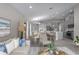 Open living room and kitchen with gray tile flooring at 12513 Oak Hill Way, Parrish, FL 34219