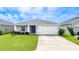 Single-story home with a two-car garage and well-manicured lawn at 16415 62Nd E Gln, Parrish, FL 34219