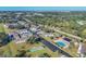 Aerial view of a community with pool, shuffleboard, and homes at 2431 Golf Course Dr # 703, Sarasota, FL 34234