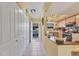 Light and airy entryway with built-in storage and open view to kitchen at 2431 Golf Course Dr # 703, Sarasota, FL 34234