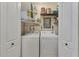 Laundry room with washer, dryer, and extra storage shelves at 2431 Golf Course Dr # 703, Sarasota, FL 34234