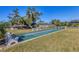 Well-maintained shuffleboard court in a sunny, grassy area at 2431 Golf Course Dr # 703, Sarasota, FL 34234