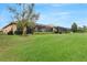 Expansive lawn with screened lanai overlooking the beautifully landscaped backyard at 340 Cedar Falls Dr, Apollo Beach, FL 33572