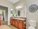 Bathroom with a single sink, granite counters, decorative mirror, and views to the laundry room at 340 Cedar Falls Dr, Apollo Beach, FL 33572