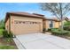 Single-Gathering home showcasing a neutral exterior and a spacious two-car garage at 340 Cedar Falls Dr, Apollo Beach, FL 33572