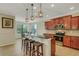 An open kitchen offers granite counters, stainless steel appliances, and pendant lighting at 340 Cedar Falls Dr, Apollo Beach, FL 33572