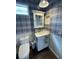 Charming bathroom with a white vanity, plaid wallpaper, and a toilet at 4707 Woodbrook Dr, Sarasota, FL 34243