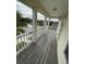 Wooden deck with white railing and street view at 4707 Woodbrook Dr, Sarasota, FL 34243