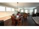 Bright dining room featuring a wood table and chairs, with an open concept to the living room at 4707 Woodbrook Dr, Sarasota, FL 34243