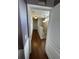 Long hallway with dark hardwood floors, leading to other rooms at 4707 Woodbrook Dr, Sarasota, FL 34243