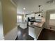 Open concept kitchen with white cabinets and dark floors at 4707 Woodbrook Dr, Sarasota, FL 34243