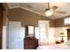 Main bedroom with a dresser, built-in shelving, and a ceiling fan at 4707 Woodbrook Dr, Sarasota, FL 34243