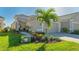 Tan two-car garage villa with landscaped walkway at 7525 Alumni Trl, Sarasota, FL 34243