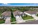 Three houses in a neighborhood with green lawns at 10739 Spring Tide Way, Parrish, FL 34219