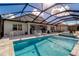 Inviting screened-in pool and spa with patio furniture at 10739 Spring Tide Way, Parrish, FL 34219