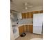 Bright kitchen features white appliances, ample cabinets, and natural light at 1208 44Th Avenue E Dr, Ellenton, FL 34222