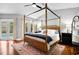Main bedroom with king-size bed, hardwood floors, and private access to the pool at 1954 Datura St, Sarasota, FL 34239