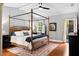 Spacious main bedroom with a four-poster bed and access to the backyard at 1954 Datura St, Sarasota, FL 34239