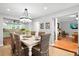 Bright dining room features a large table, chandelier, and view into the kitchen at 1954 Datura St, Sarasota, FL 34239
