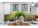 Dining area with wood table, rattan chairs, and a large vase at 1954 Datura St, Sarasota, FL 34239