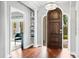 Elegant entryway with hardwood floors, a statement chandelier, and built-in shelves at 1954 Datura St, Sarasota, FL 34239
