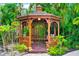 Relaxing wooden gazebo nestled in a lush tropical garden, perfect for outdoor enjoyment at 1954 Datura St, Sarasota, FL 34239