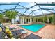 Relaxing pool area with a screened enclosure, lounge chairs, and a gazebo at 1954 Datura St, Sarasota, FL 34239