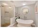 Spa-like bathroom with a freestanding bathtub and a walk-in shower at 3927 Somerset Dr, Sarasota, FL 34242