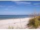 Scenic beach view with white sand and sailboat in distance at 1080 Piedmont Rd, Venice, FL 34293