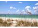 Scenic beachfront view with sea oats and a calm ocean at 1080 Piedmont Rd, Venice, FL 34293