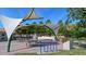 Relaxing community park with shaded seating, picnic tables, water feature, and bike rack at 1080 Piedmont Rd, Venice, FL 34293
