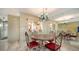 Small dining area with a round table, red chairs, and a chandelier at 1080 Piedmont Rd, Venice, FL 34293