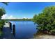 Wooden dock by waterway with lush foliage at 1080 Piedmont Rd, Venice, FL 34293