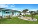 Well-manicured front yard with lush green grass, decorative landscaping, and solar panels enhances this home's appeal at 1080 Piedmont Rd, Venice, FL 34293