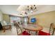 Bright living room with a large TV, comfy seating, and a tiled dining area at 1080 Piedmont Rd, Venice, FL 34293