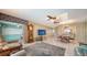 Bright and airy living room with access to a screened porch at 1080 Piedmont Rd, Venice, FL 34293