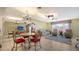 Open living room with ample seating, a large TV, and a view of the dining area at 1080 Piedmont Rd, Venice, FL 34293